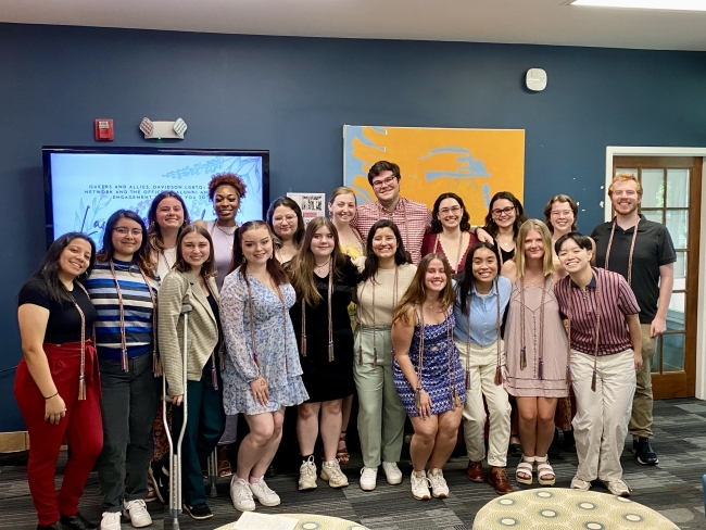 Group of students with graduation cords smiling