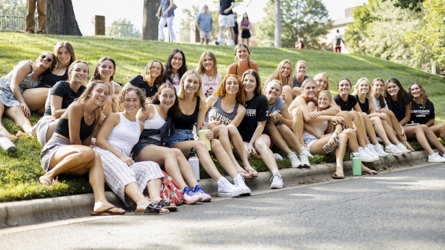 students sit and cheer on the cake race runners