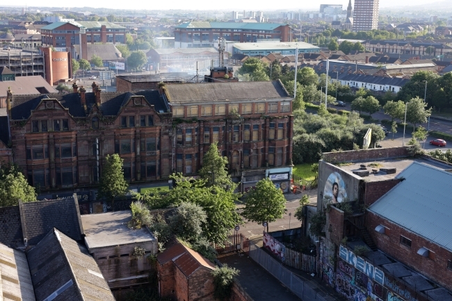 a small city with green trees and old brick buildings