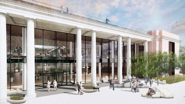 a modern looking library with white columns and green trees