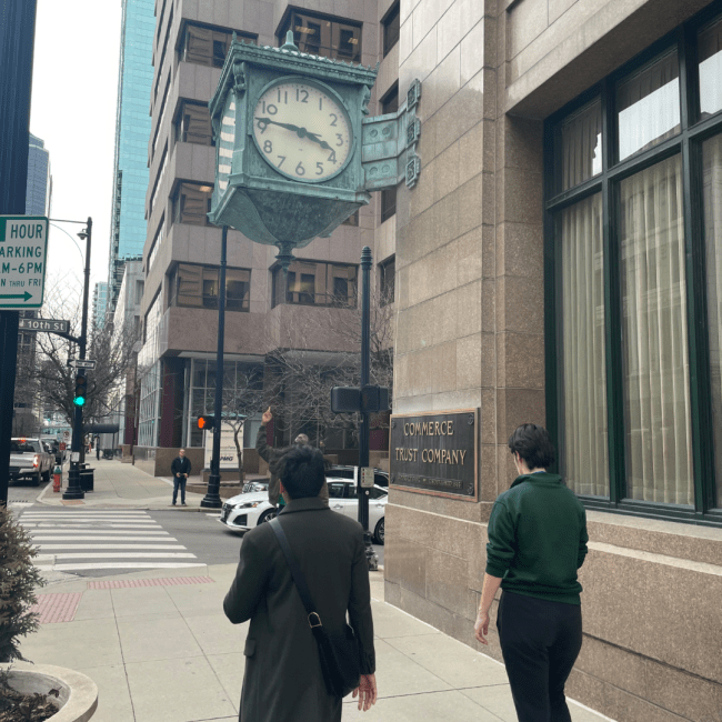 two young people walk a city street