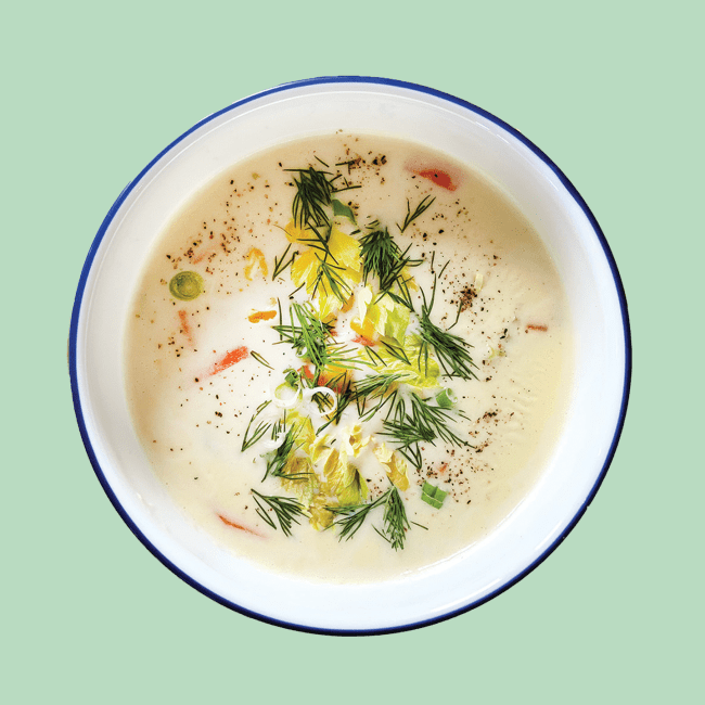 Creamy bowl of soup with dill and lemon zest garnish