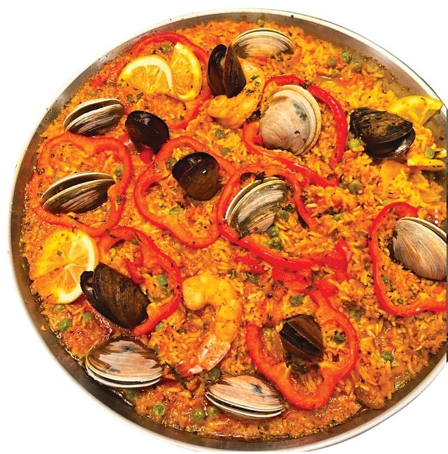 Dish with rice and mussels, lemons and red peppers