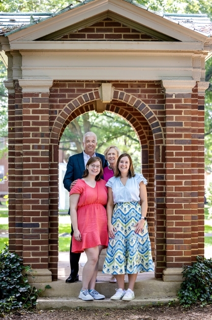 a white family consisting of a male, female and two daughters