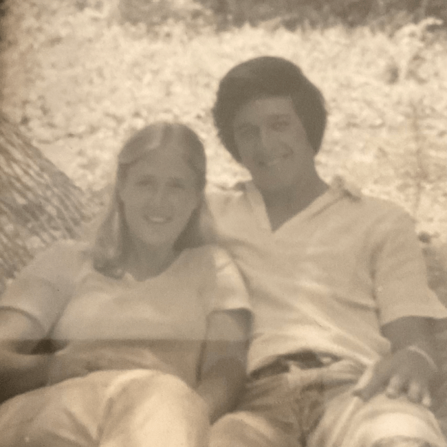 a black and white photo of a young man and woman