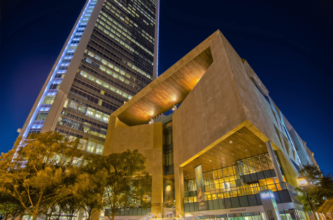 a modern structure lit up at night