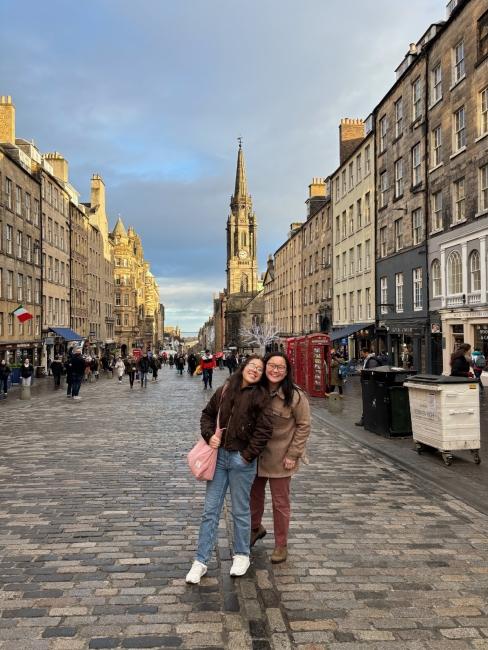 two young people stand on a street in Edinburgh, Scotland