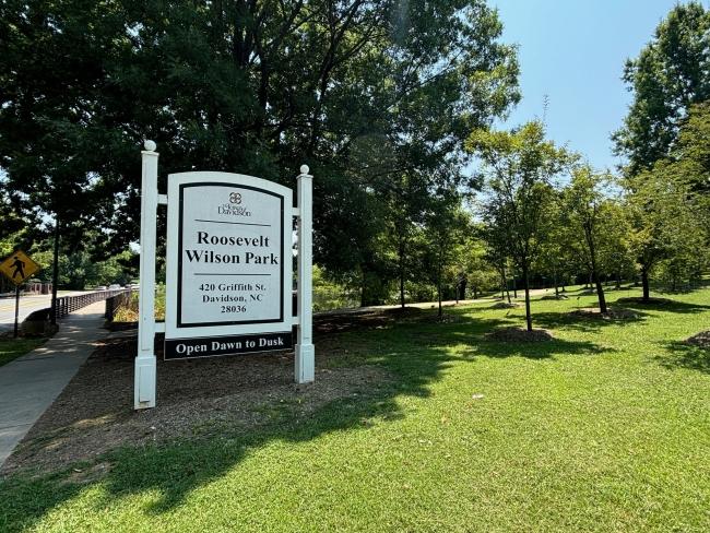 a park with a sign in front of it reading "Roosevelt Wilson Park"