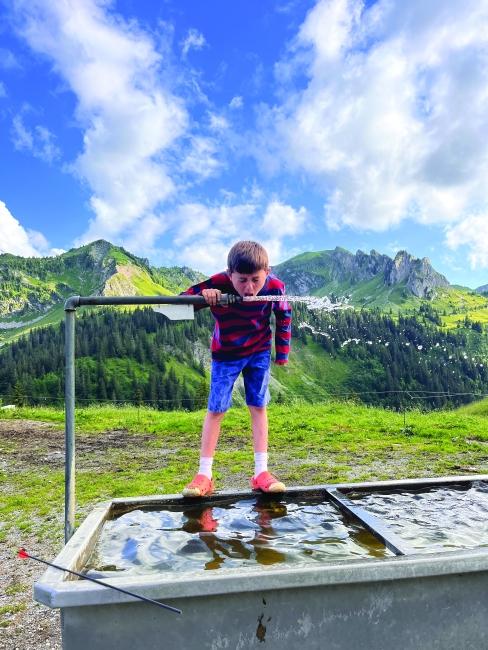 Child taking a sip of water in Switzerland Status message