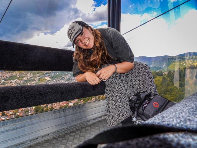 a young woman sitting on a gondola and smiling