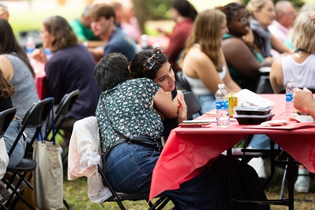 Two people hug at the orientation picnic