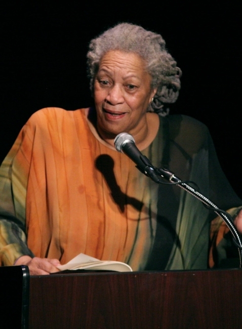 an older Black woman speaking into a microphone on stage