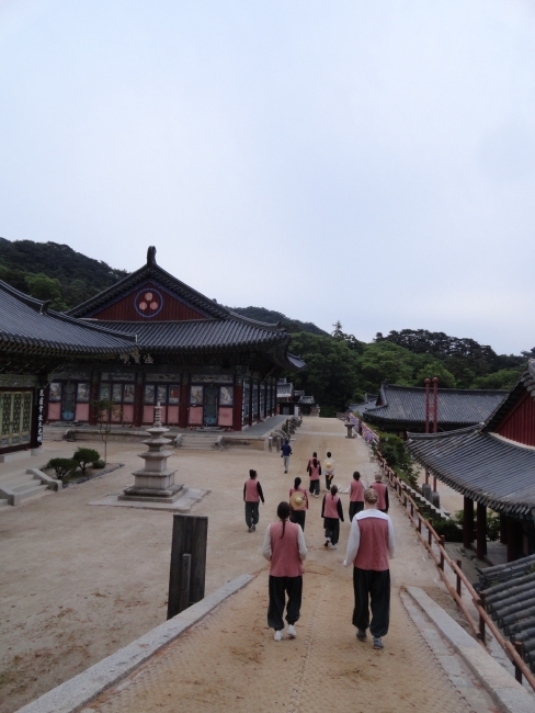 a group of students walking to morning service at Buddhist temple