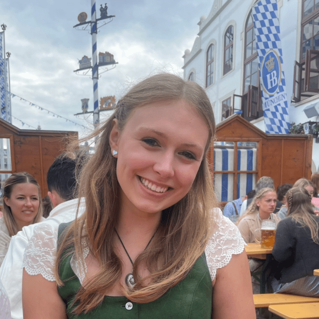 a young white woman smiling outside