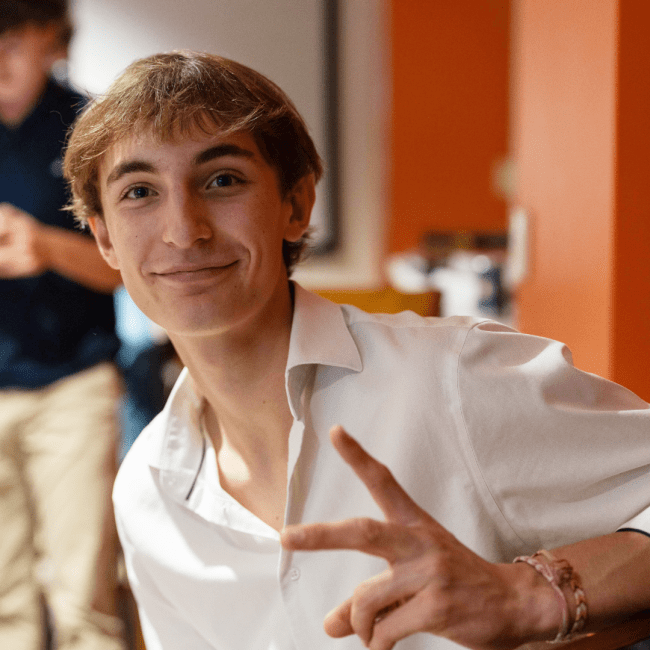 a young white man wearing a collared shirt and smiling