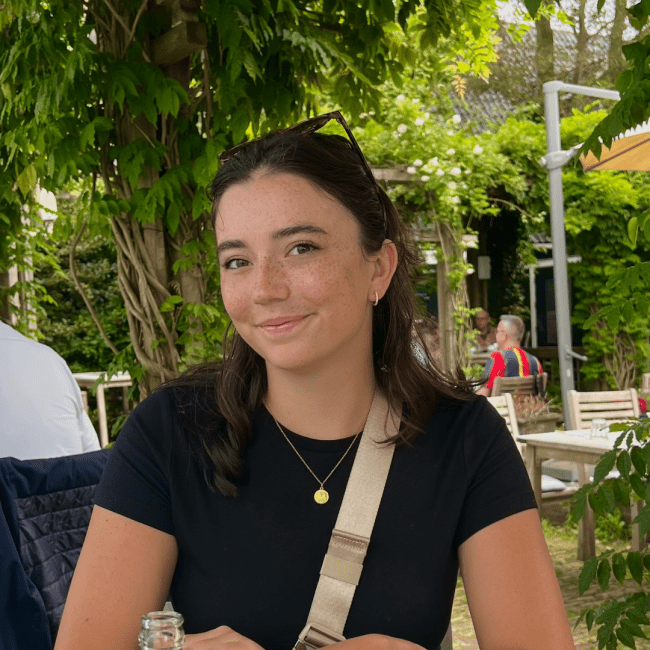 a young white female wearing a black top and sunglasses