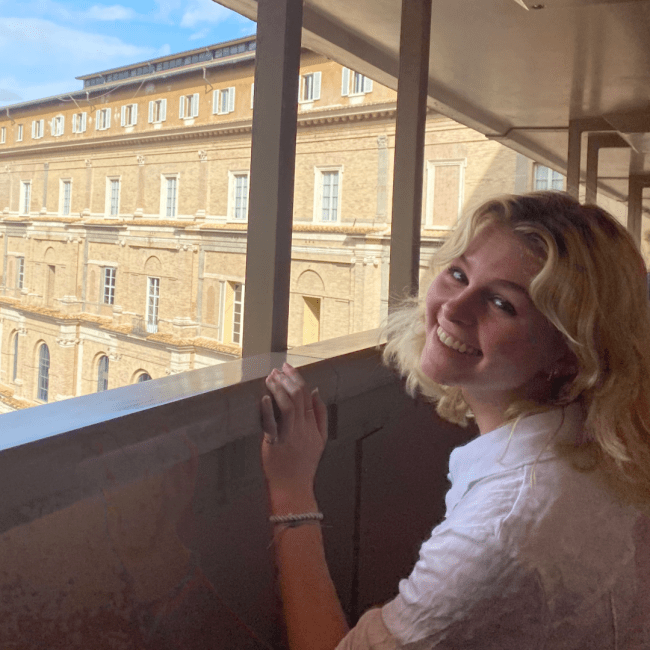 a young white woman overlooking a city