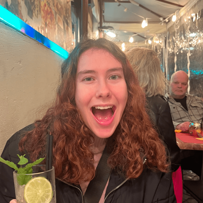 a young white woman smiling in a restaurant