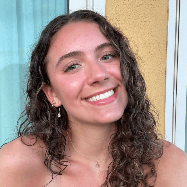 a young white woman with curly hair smiling