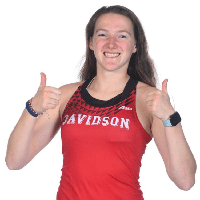 a young white woman smiling and giving thumbs up in a Davidson uniform