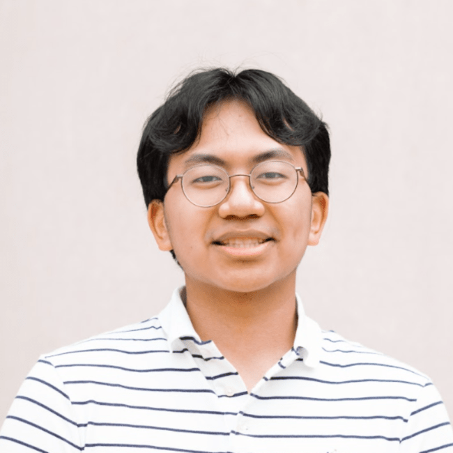 a young male wearing glasses and a striped shirt