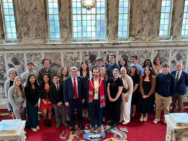 a group of people standing together in an old city hall