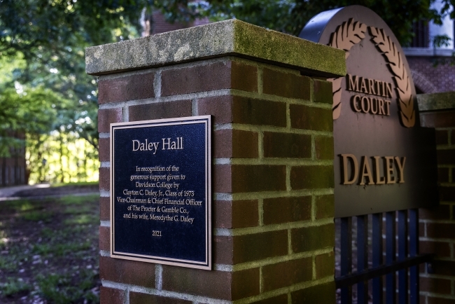 a brick gate with a sign reading "Daley Hall"