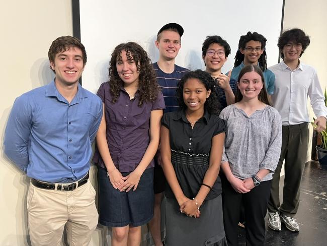 a group of eight students standing together and smiling