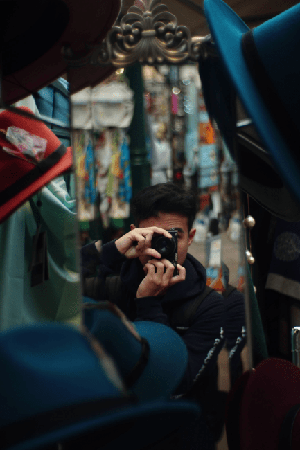 a young man takes a picture on a camera