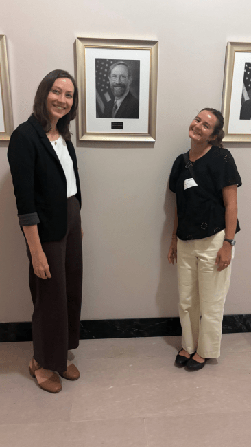 a young woman and her professor pose together