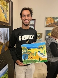 Art Dialogue event student holding his artwork