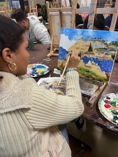 Art Dialogue student painting a landscape