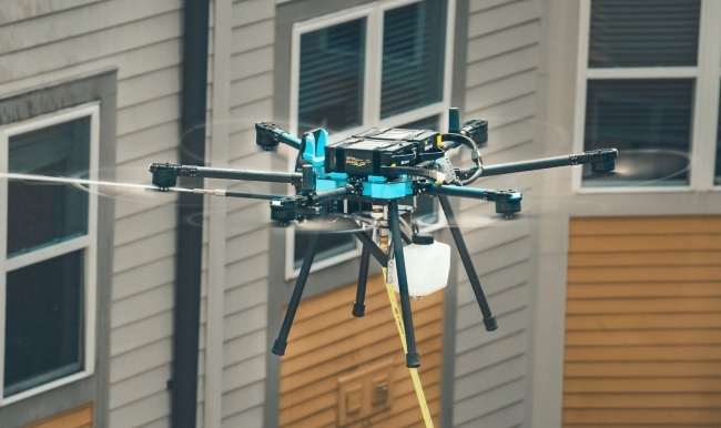 a drone cleans the side of a building