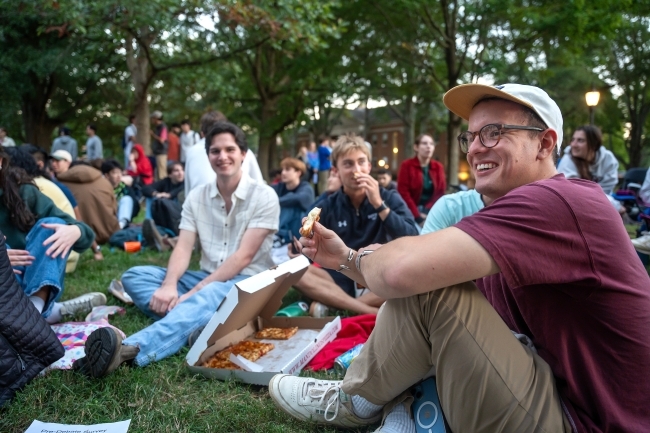 Students eating pizza at the Phi Eu Debate