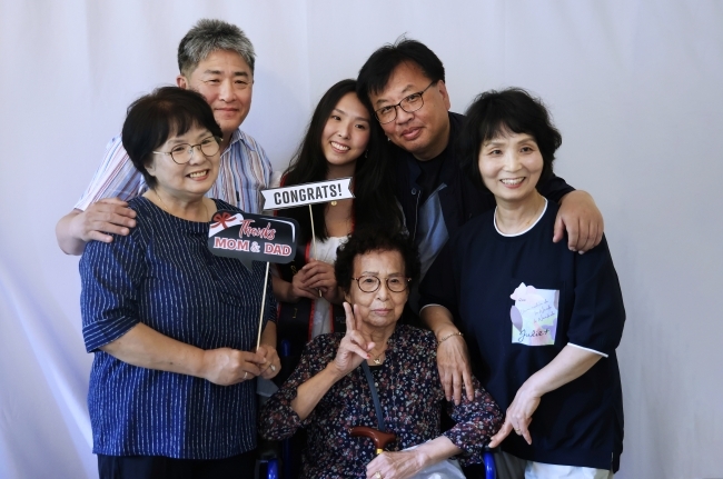 an Asian family together smiling