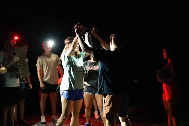 student activity at night during davidson outdoors trip