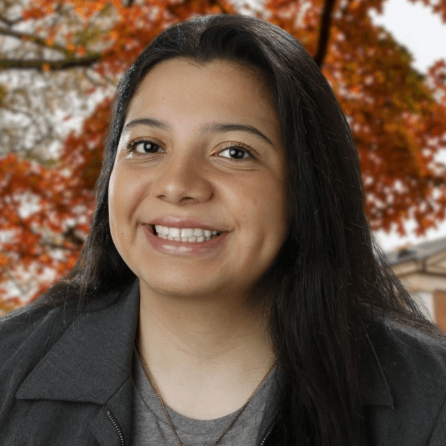 a young woman with dark brown hair smiling