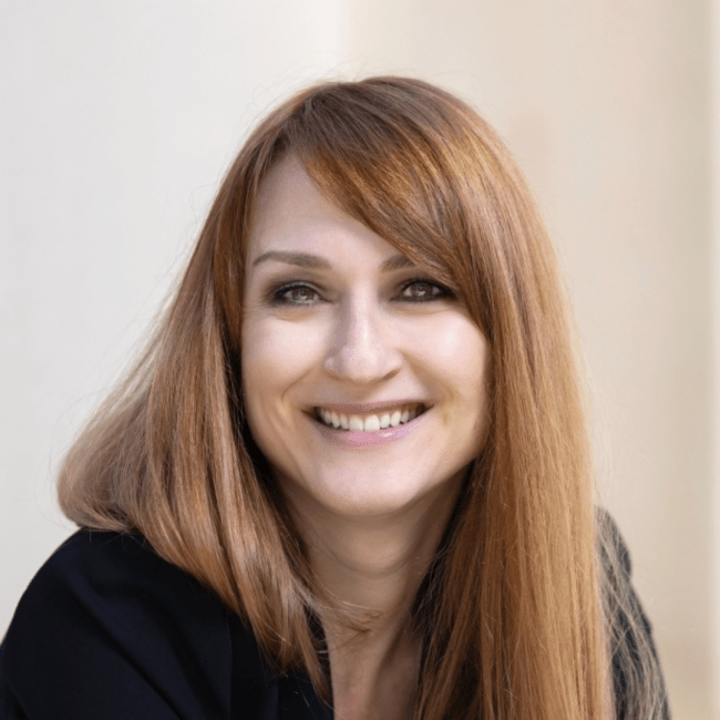 a woman with red hair smiling