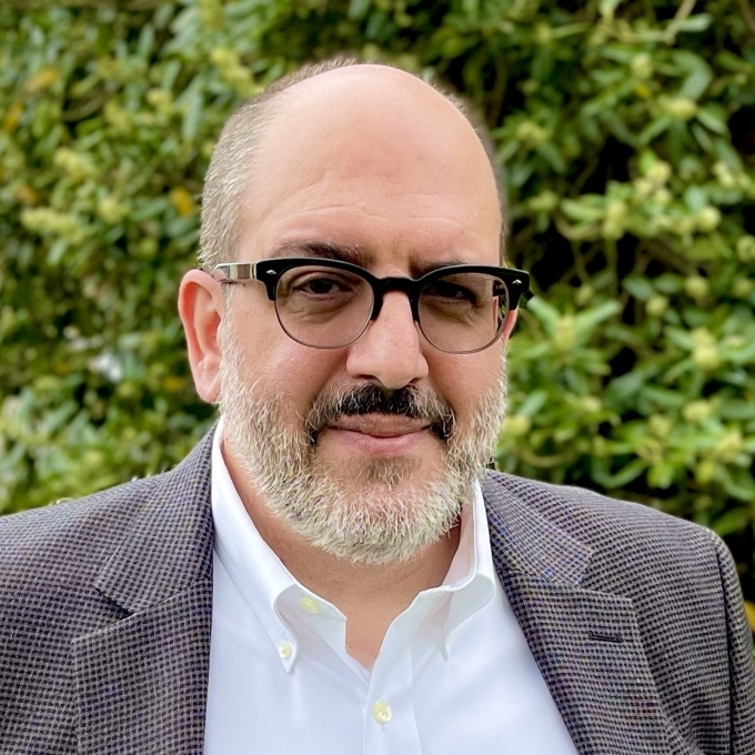 an older man wearing a jacket and glasses