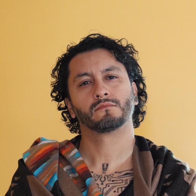 a young man with black curly hair 