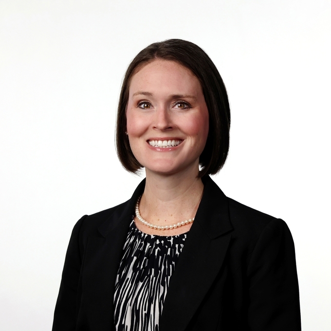 a young white woman with short brown hair wearing a black blazer