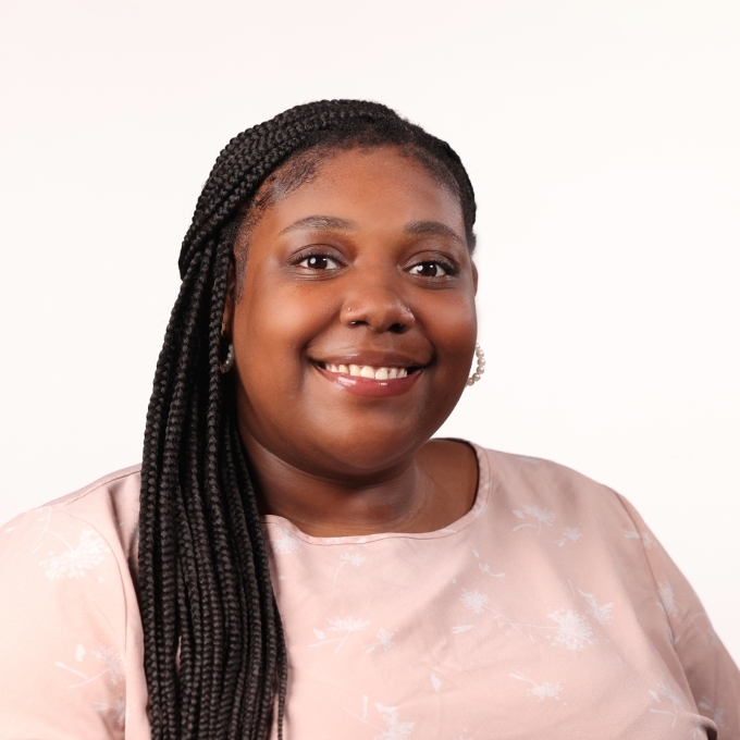 a young Black woman wearing a pink top