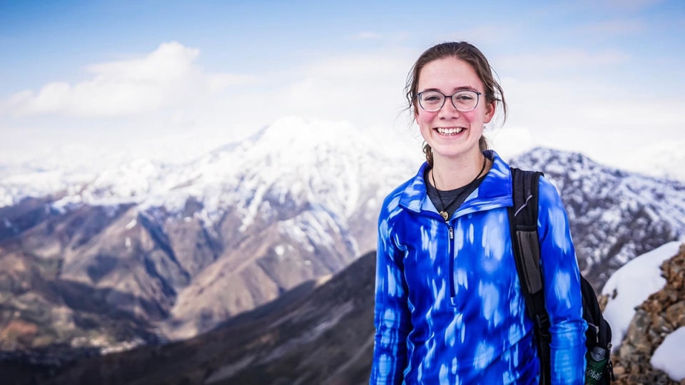 Catherine Cartier poses in front of mountain landscape