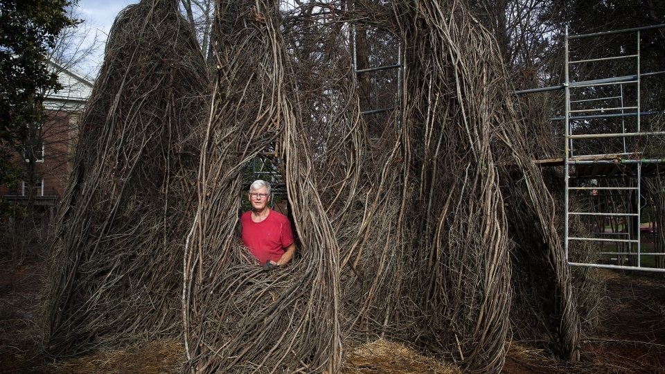 Patrick Dougherty Sculpture with artist