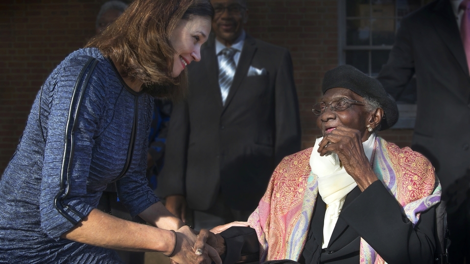 Carol Quillen shakes hands with Lula Bell Houston