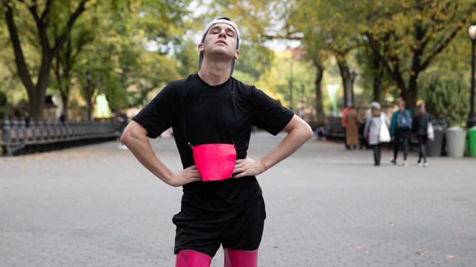 Davidson College alum Dan Van Note '14 in thigh-high boot heels with sneakers on ground for 2019 Endurance Queen performance