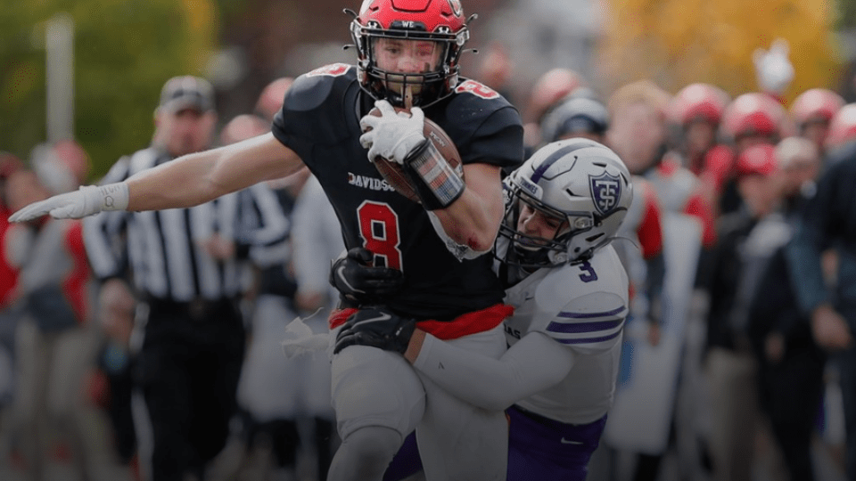 Davidson Football Player Clutching Ball While Running