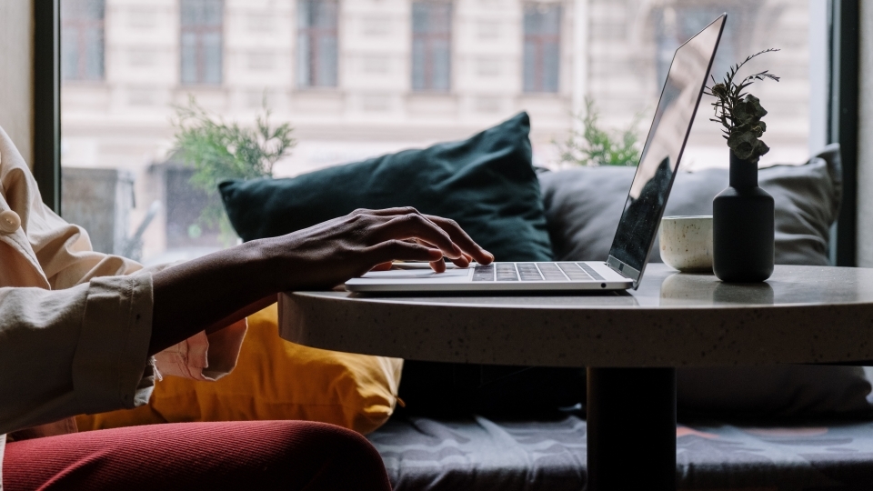 silhouette of hands on laptop