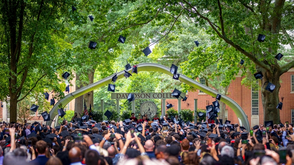 Graduation caps in air during ceremony