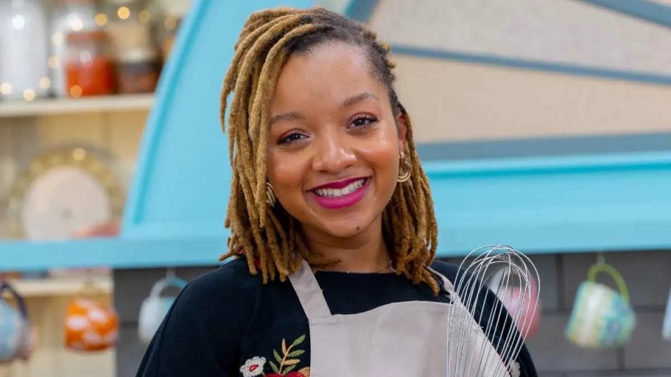 Karis Stucker '18 holding a whisk on the The Great American Baking Show